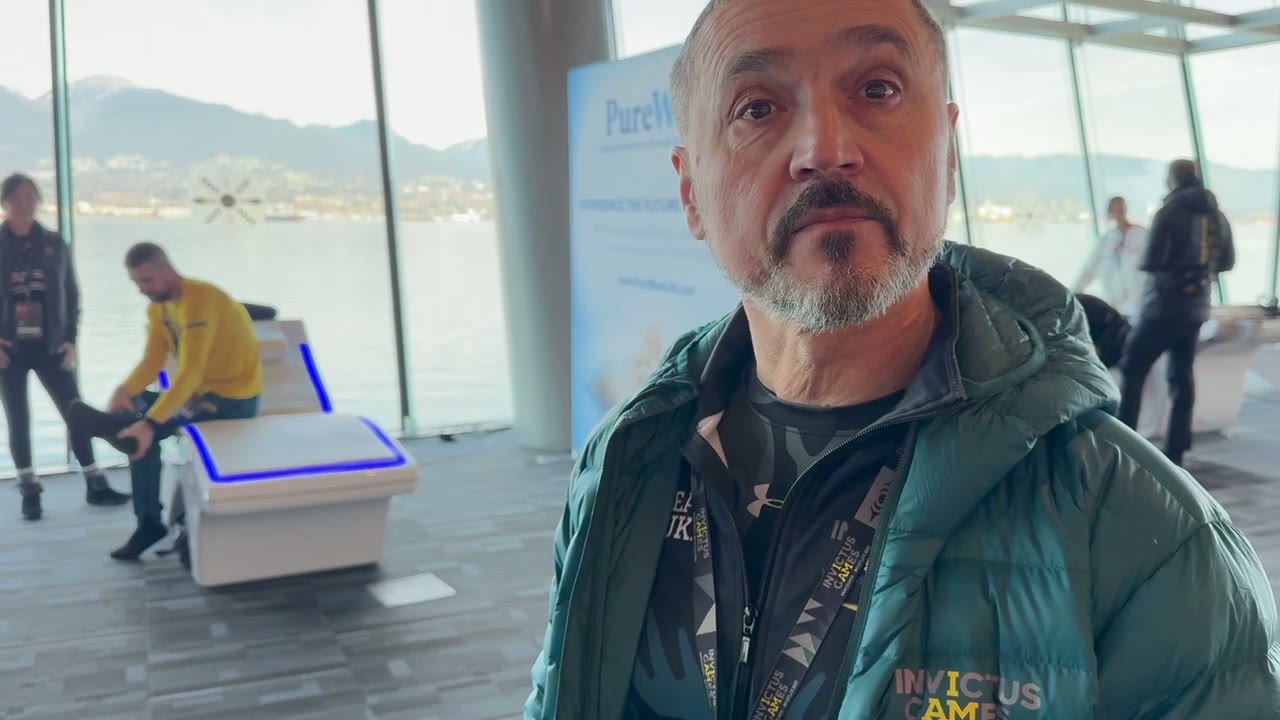 Invictus Games competitor beside a PureWave system overlooking the harbour